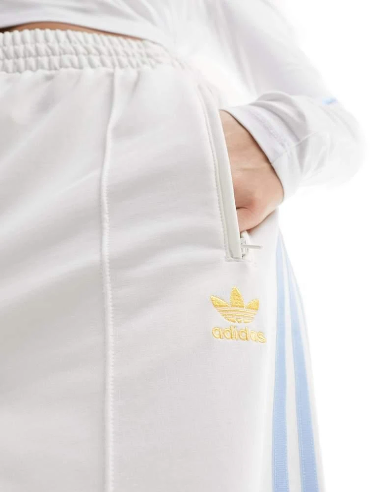 Adidas adidas Originals three stripe track pants in off white and blue 2
