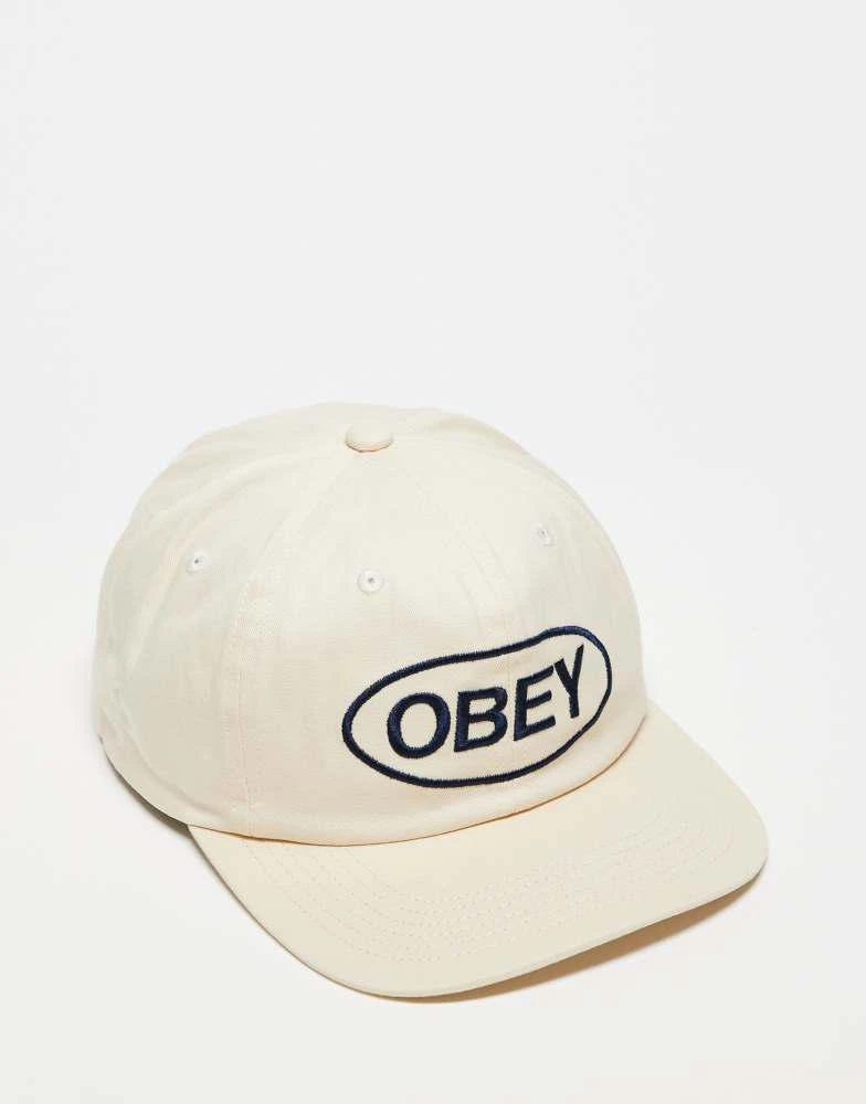 Obey Obey obey oval 6 panel strapback logo cap in off white 1