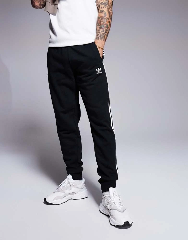 Adidas adidas Originals three stripe joggers in black 4