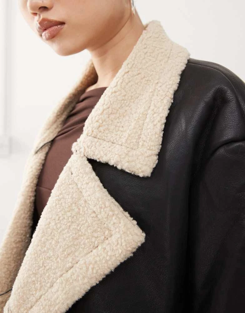 Princess Polly Princess Polly leather look contrast faux shearling button front longline coat in black and beige 3
