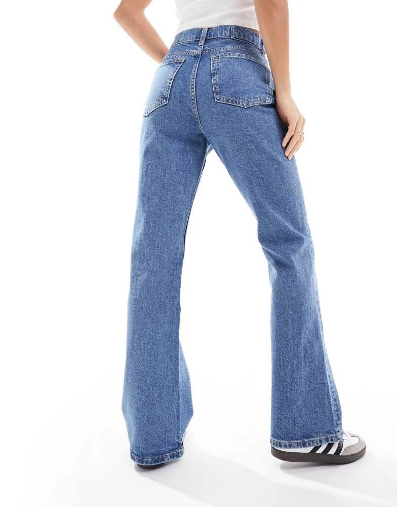 ASOS ASOS DESIGN Petite mid rise flare jeans in mid blue 2