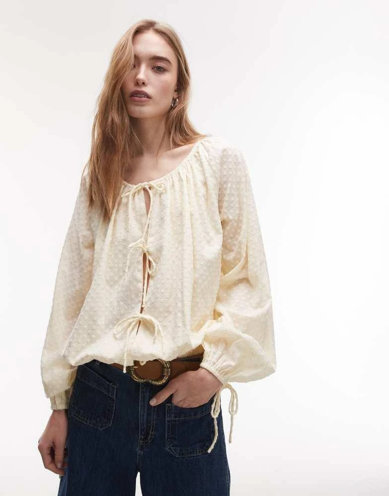 Topshop Topshop dobby ruched neck tie front top in buttermilk from ASOS