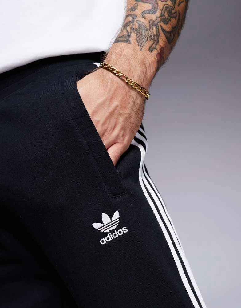 Adidas adidas Originals three stripe joggers in black 5