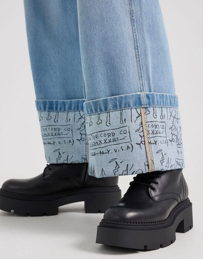 LEE Lee x Jean-Michael Basquiat capsule scribble artwork inside turn up loose carpenter jeans in light wash 2