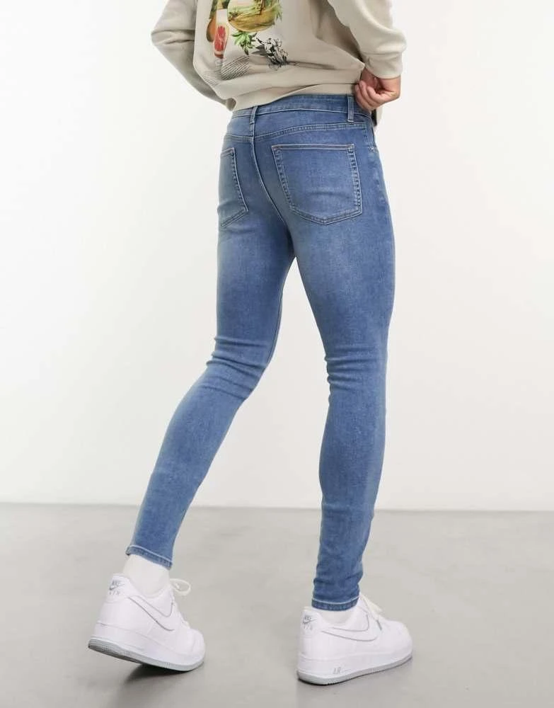 ASOS ASOS DESIGN power stretch jeans in mid wash blue 4