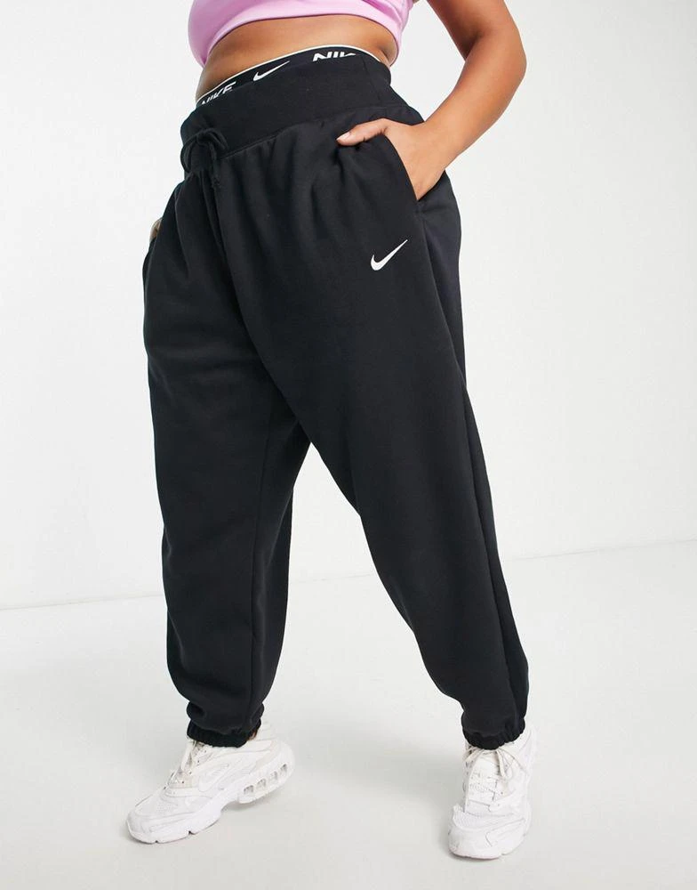 NIKE Nike Plus mini swoosh oversized high rise joggers in black and sail 4