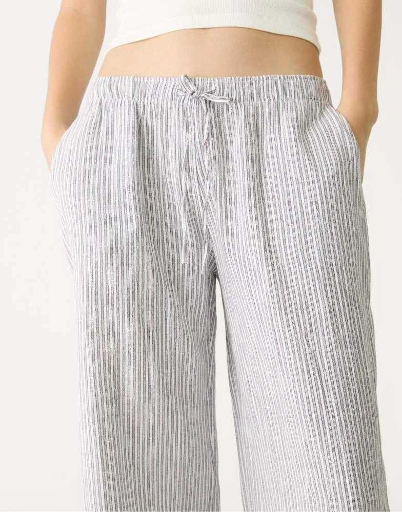 Shop Stradivarius Flowing striped linen blend trousers in brown on