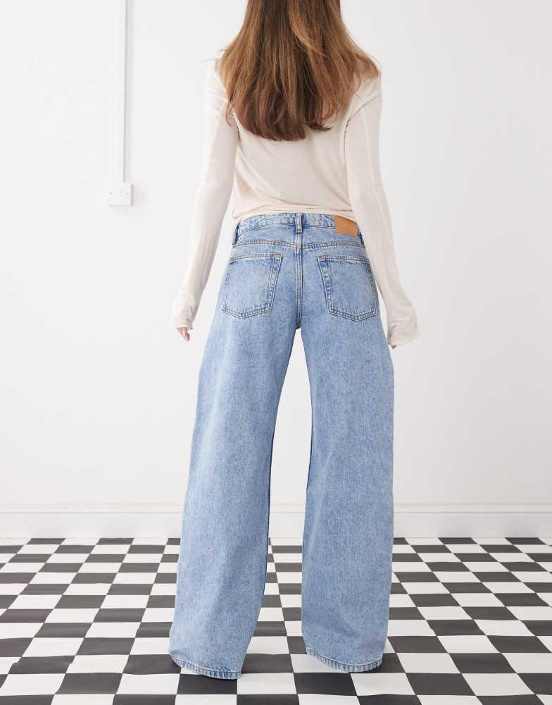 Monki Monki Imoo low waist wide leg jeans with cut out bow details in light blue wash