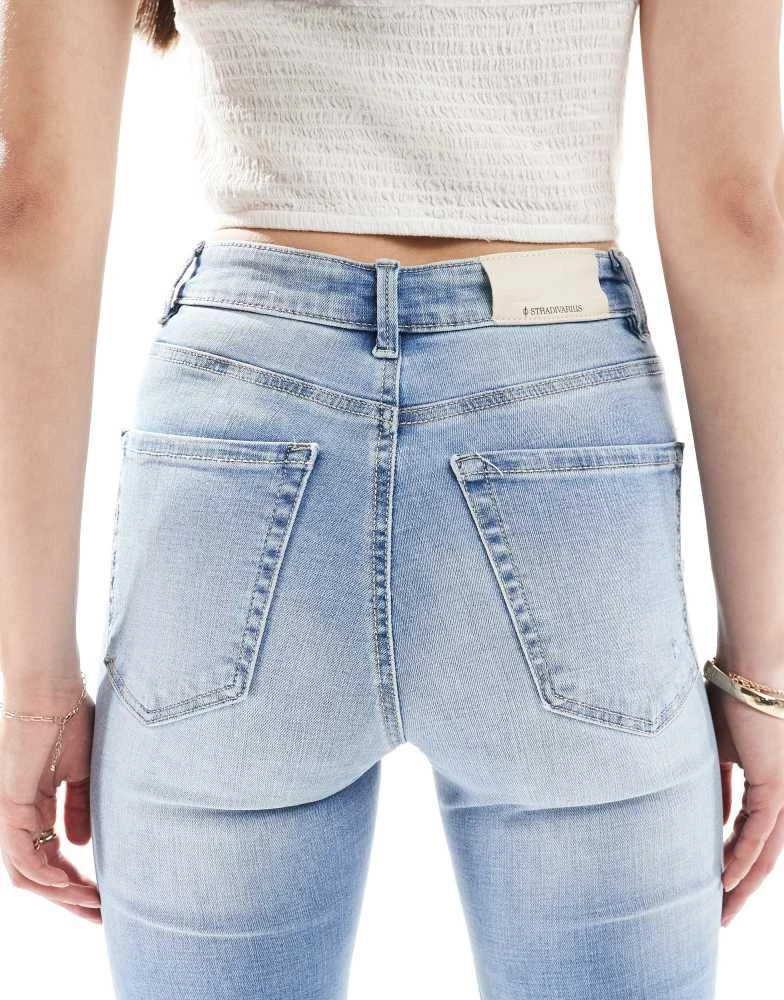 Stradivarius Stradivarius Tall D74 flare slit jean in medium wash 4