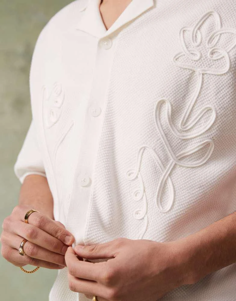 ASOS ASOS DESIGN relaxed boxy fit knitted button through polo with floral embroidery in ecru 4