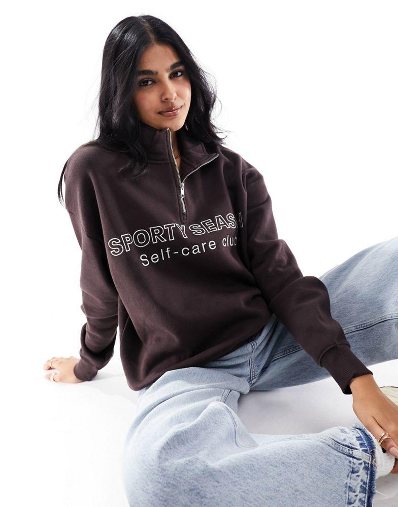 Pull&Bear Pull&Bear 'Sporty Season' graphic half zip sweater in chocolate brown