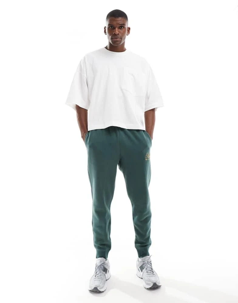 NIKE Nike Club festive joggers in dark green 5