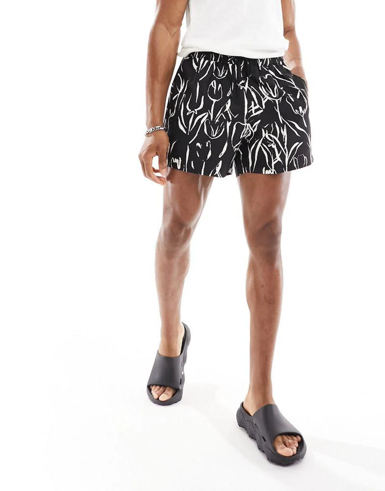 ASOS ASOS DESIGN swim shorts in short length in black and white floral print 2
