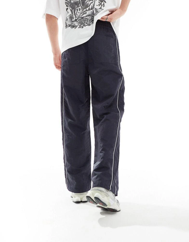 ASOS ASOS DESIGN baggy nylon track pants with white piping in navy 5
