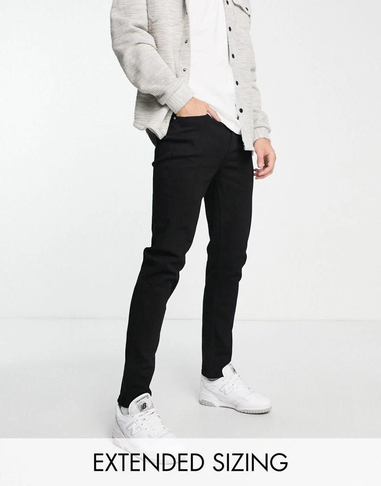Shop ASOS DESIGN tapered jeans in black on Sale at BeyondStyle - Main Image