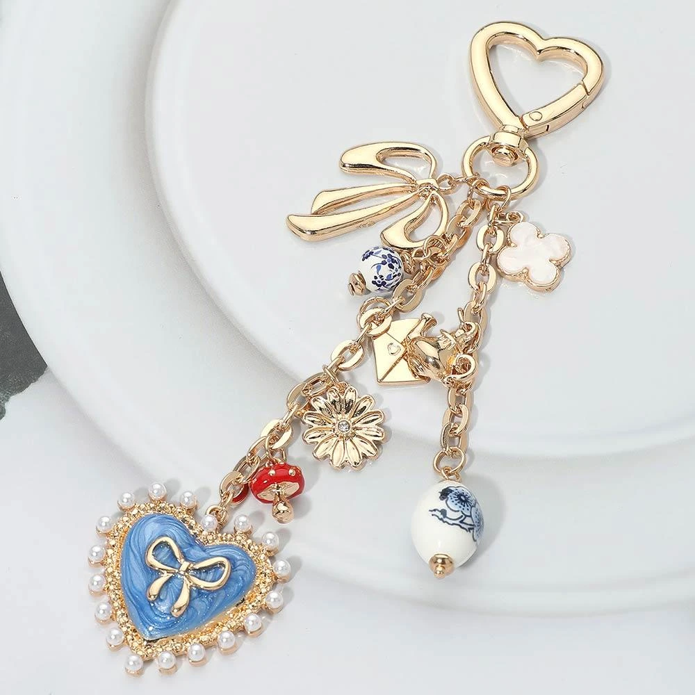 FASHNZFAB Pearl Trip Bow Heart Charm Drop Quatrefoil Flower Mushroom Envelope Charm Embellished Keychain Bag Charm