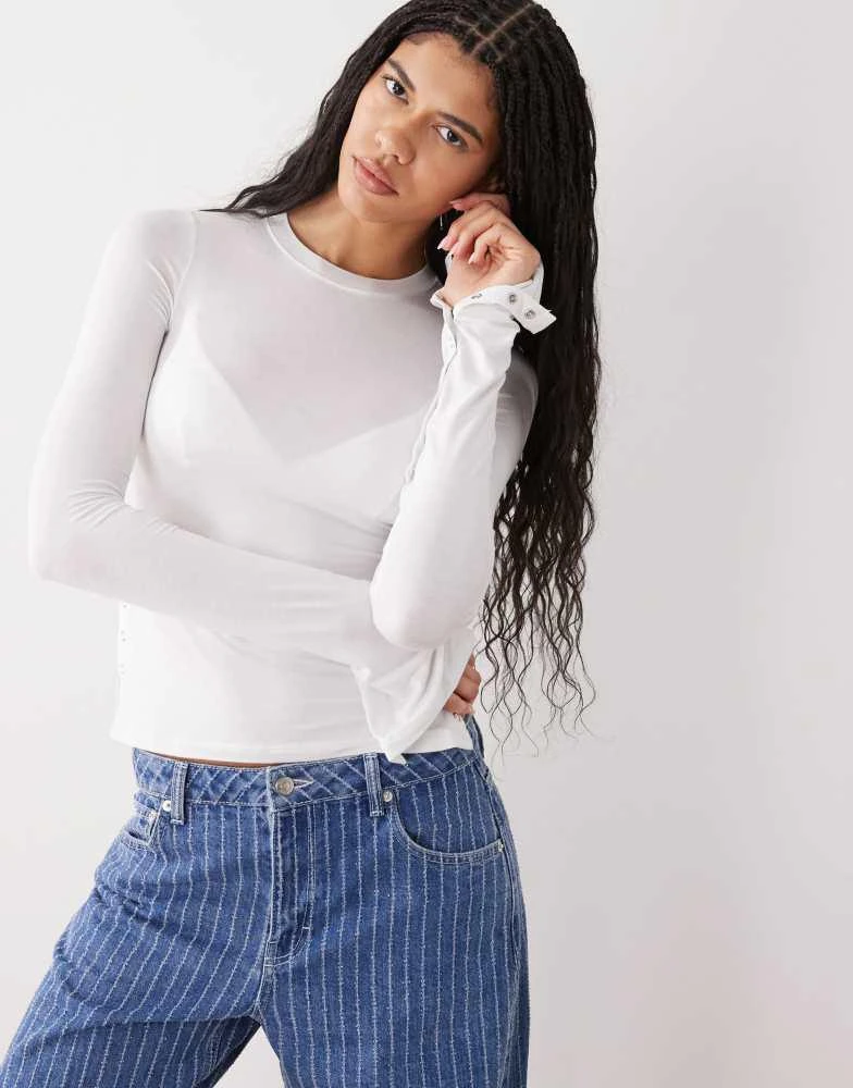 Weekday Weekday long sleeve fitted top with button detailing and asymmetric hem in off white