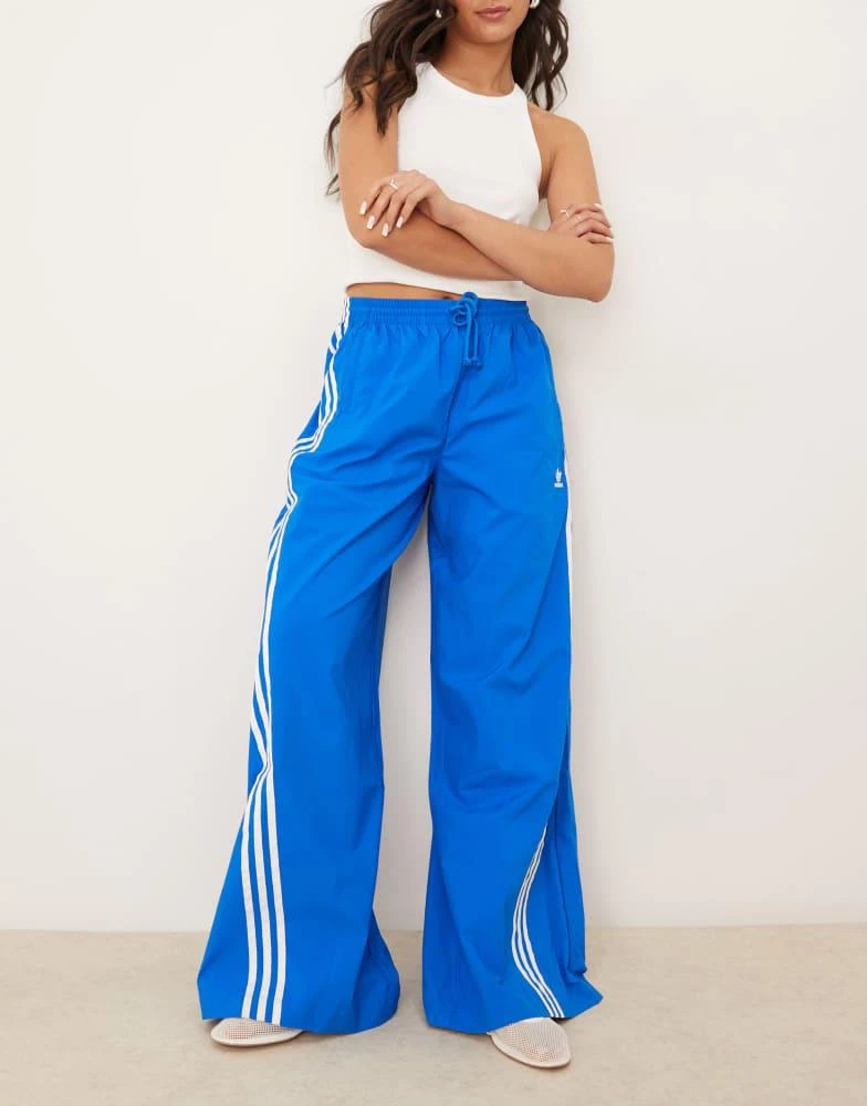 Adidas adidas Originals three stripe oversized track pants in blue 1