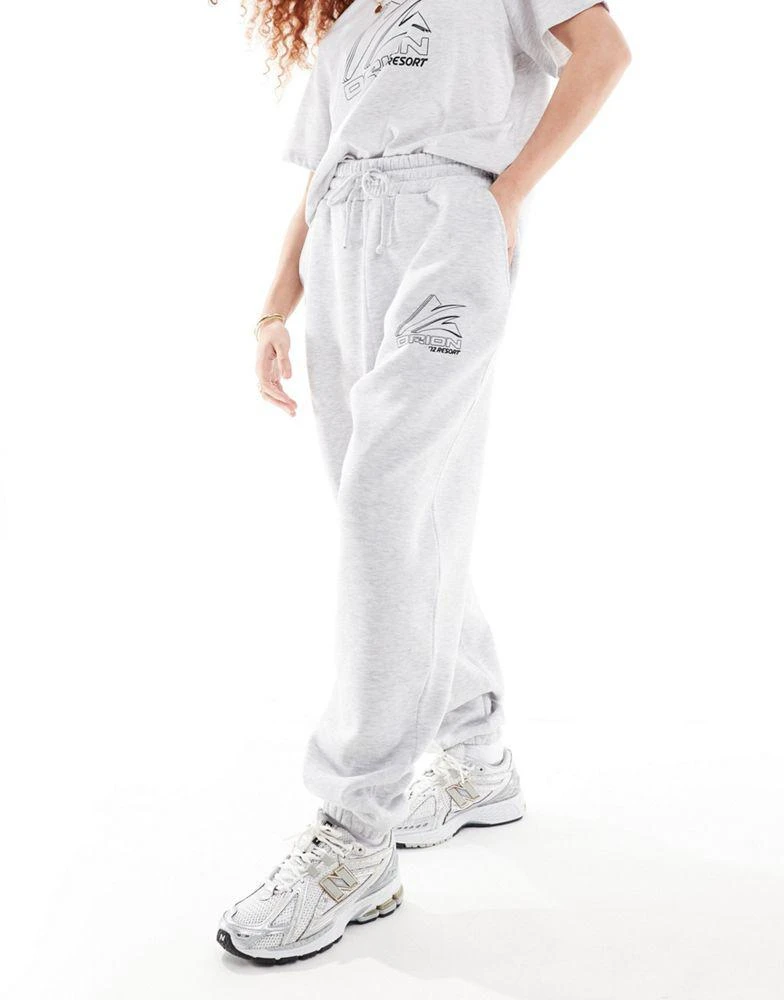 Shop ASOS DESIGN jogger co-ord with sports graphic logo in ice