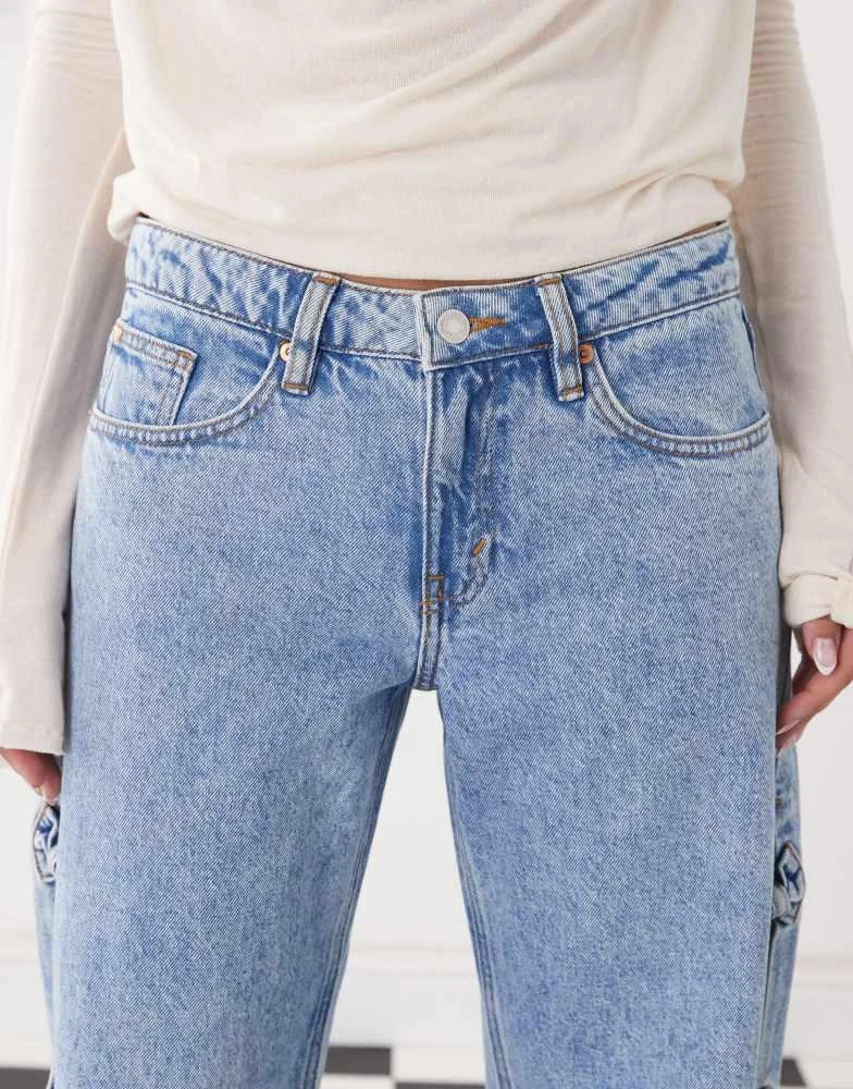Monki Monki Imoo low waist wide leg jeans with cut out bow details in light blue wash 5