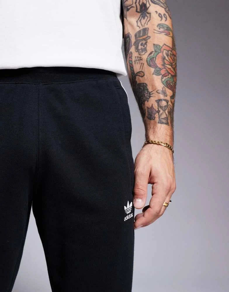 Adidas adidas Originals three stripe joggers in black 2