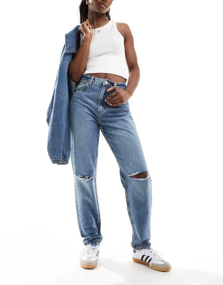 ASOS ASOS DESIGN high rise relaxed mom jeans with rips in mid blue 1