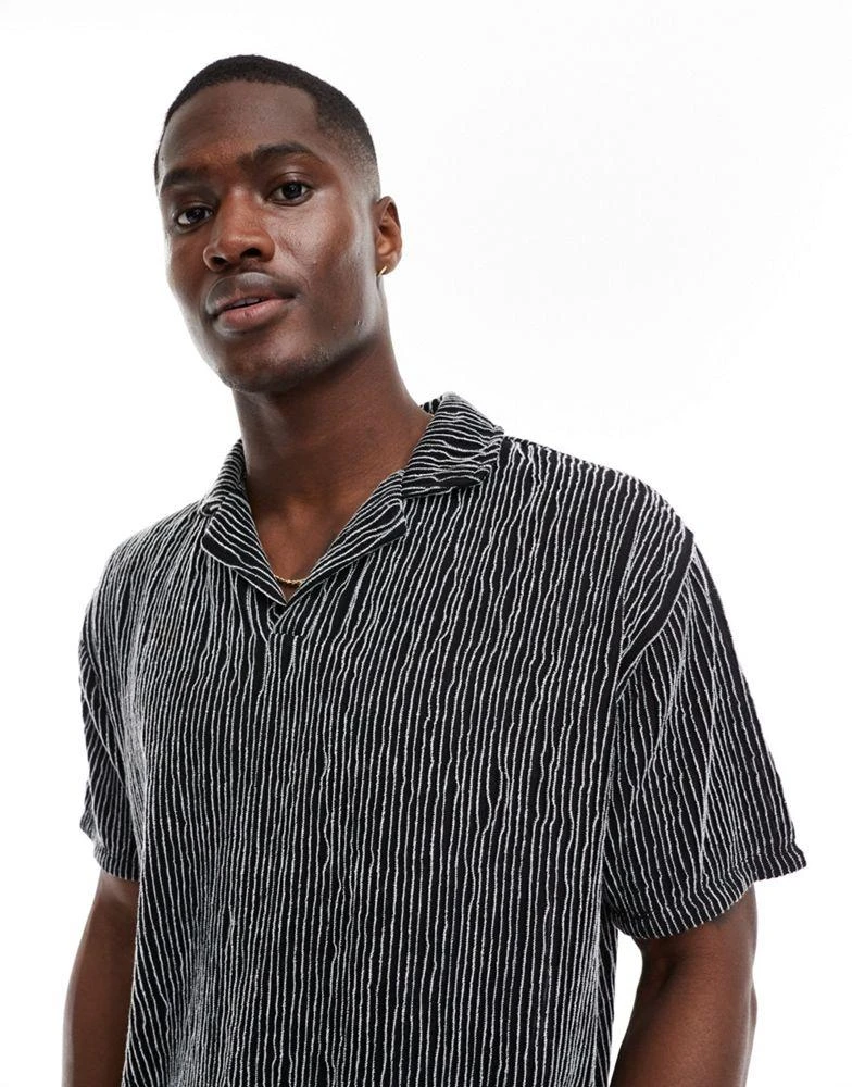 ASOS ASOS DESIGN relaxed revere polo in black textured stripe 1