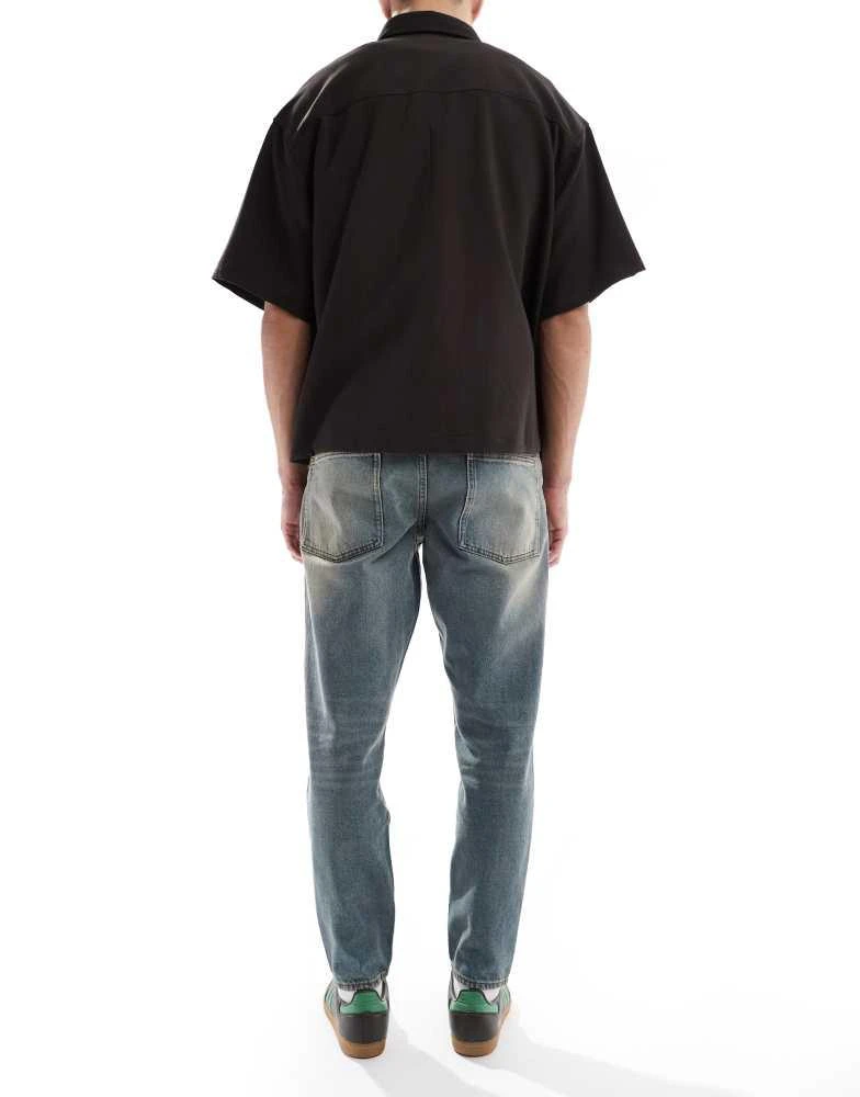 ASOS ASOS DESIGN tapered jeans with tint in light wash blue 3