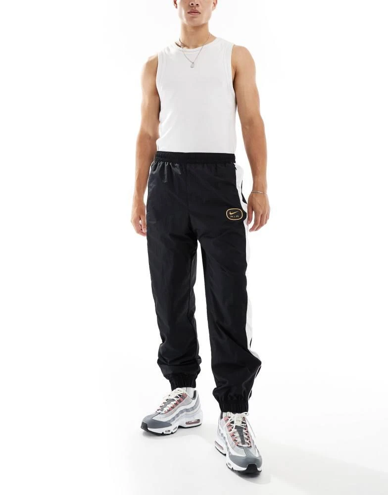 NIKE Nike Swoosh Air woven joggers in black and white 1