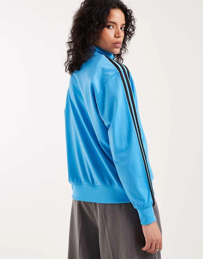 Adidas adidas Originals Firebird loose track top in blue and brown 4