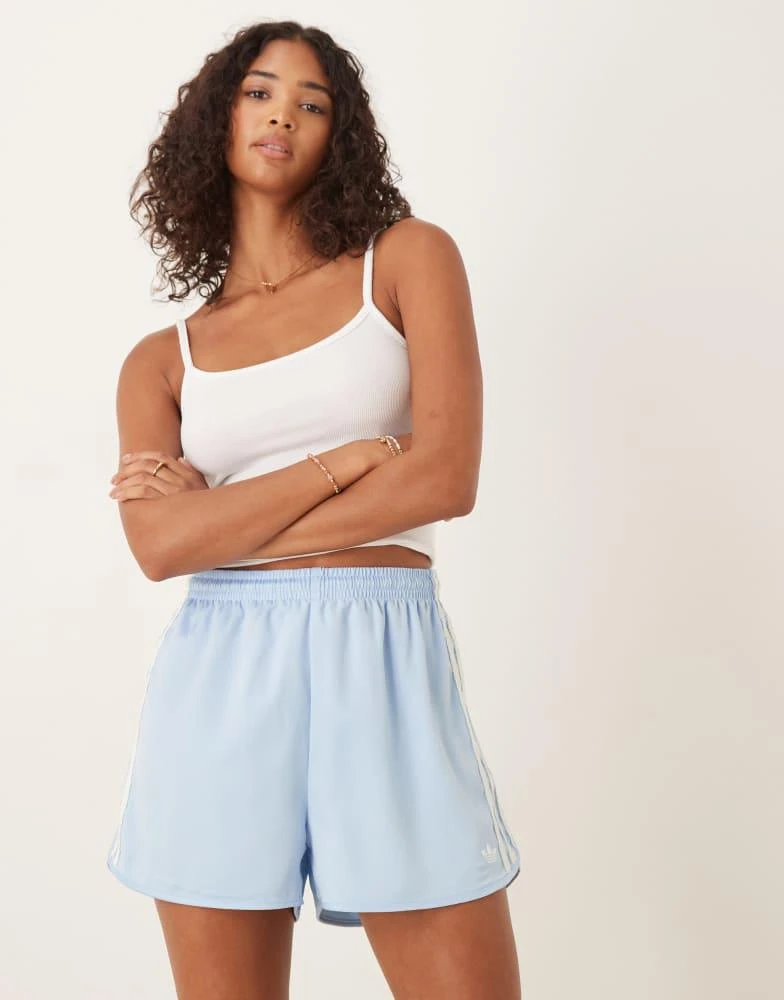 Shop adidas Originals satin sprinter shorts in blue with ruffle