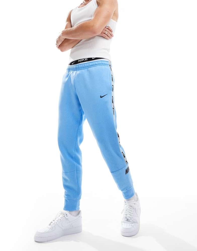 Nike Nike Repeat logo joggers in blue Pants BeyondStyle