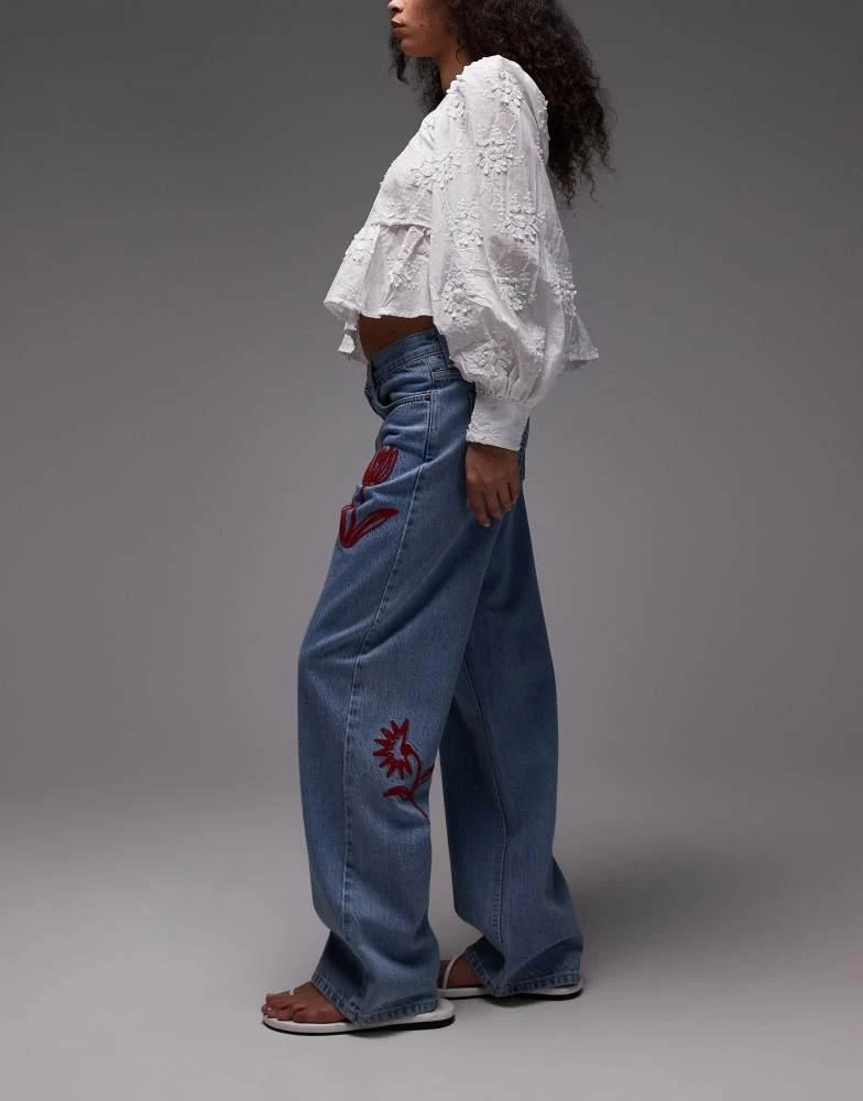 Topshop Topshop mid rise loose fit jean with red floral embroidery in mid blue 3