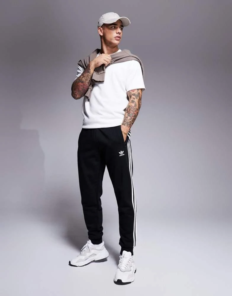 Adidas adidas Originals three stripe joggers in black 1