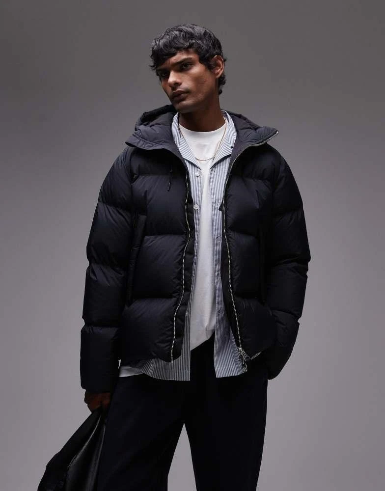 https://a0.cdn.hhv.de/items/images/generated/970x970/01304/1304232/4-gramicci-down-puffer-hooded-jacket-brown.webp