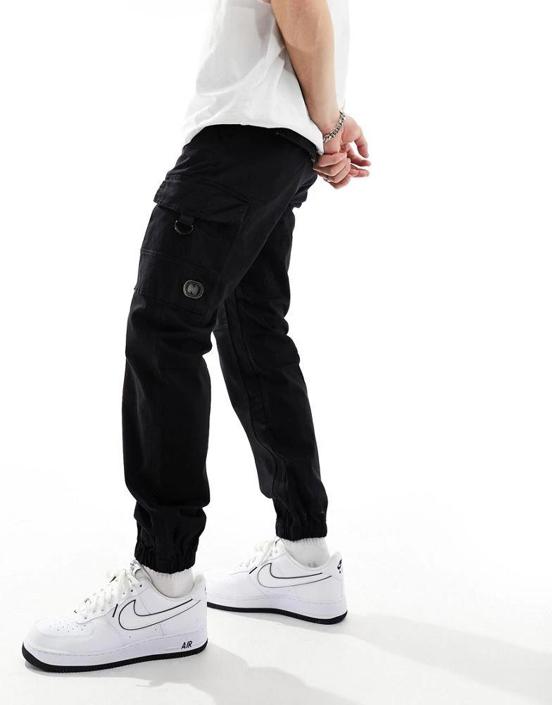 Criminal Damage Criminal Damage cuffed leg cargo pants with side leg army pockets in black 1