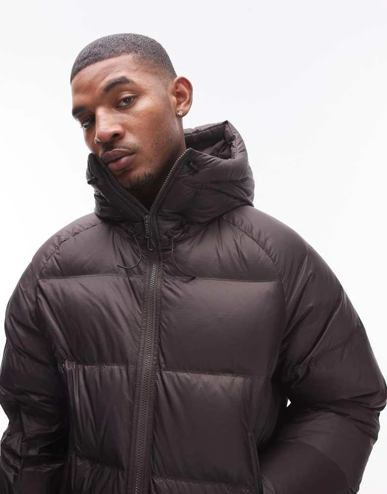 Shop ARKET sporty down jacket with hood in brown on Sale at