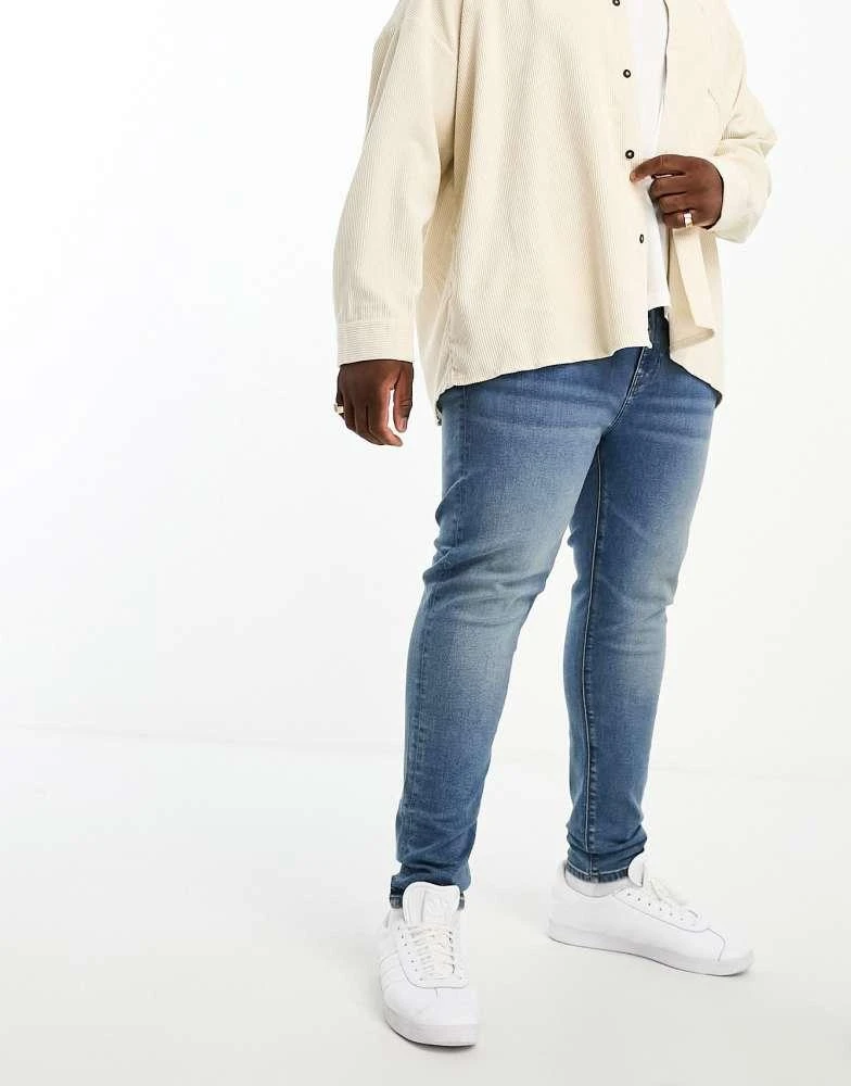 ASOS ASOS DESIGN power stretch jeans in mid wash blue 2
