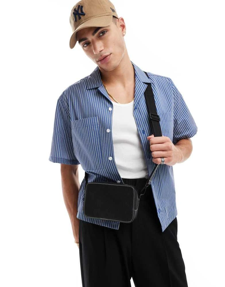 ASOS ASOS DESIGN faux leather cross body camera bag in black with contrast stitch 1