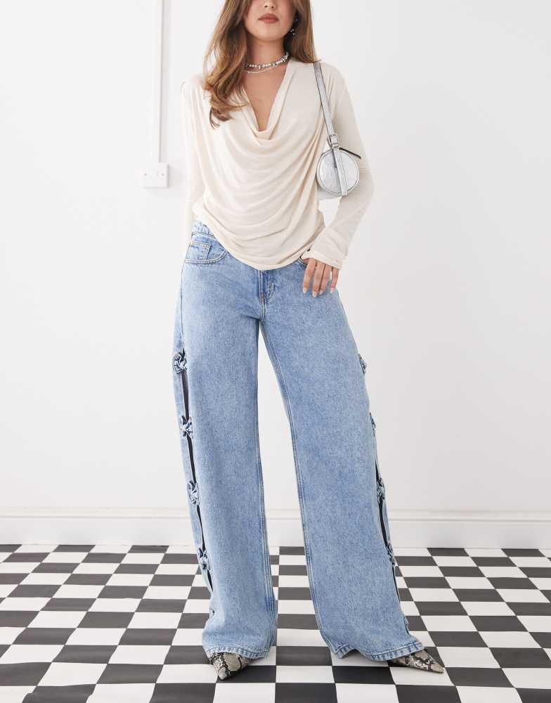 Monki Monki Imoo low waist wide leg jeans with cut out bow details in light blue wash