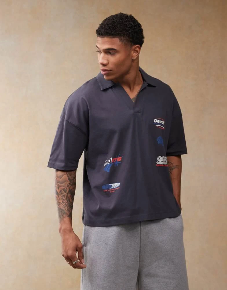 ASOS ASOS DESIGN boxy oversized polo with dropped shoulder and multiplacement sport print in navy 1
