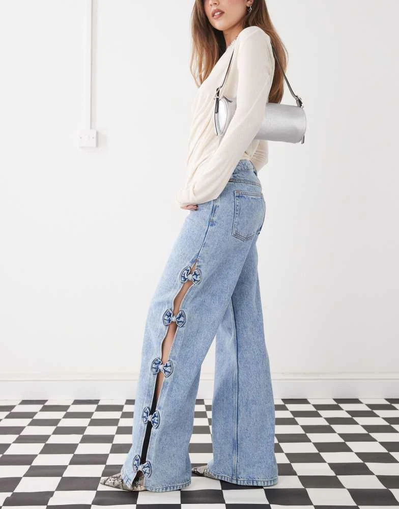 Monki Monki Imoo low waist wide leg jeans with cut out bow details in light blue wash 3