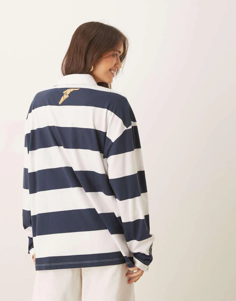 Shop ASOS DESIGN unisex oversized long sleeve polo with Goodyear