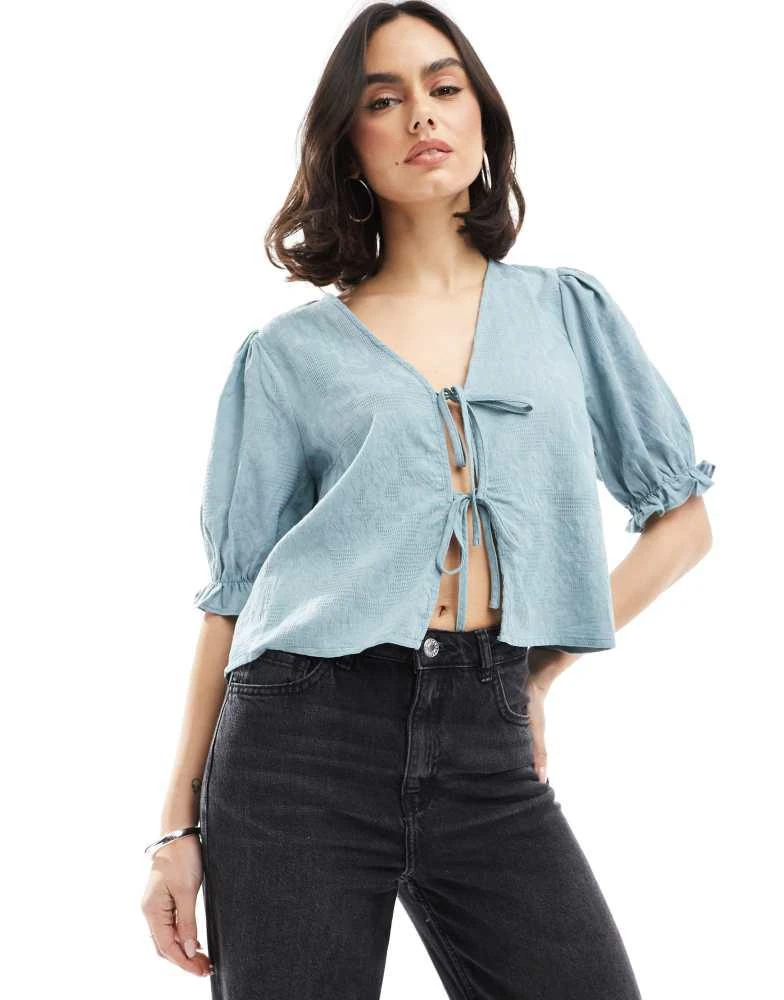 Pieces Pieces jaquard detail tie front puff sleeve top in soft blue 1