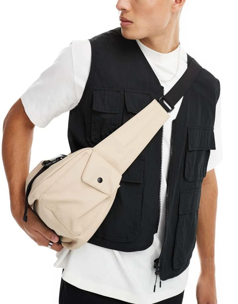 ASOS ASOS DESIGN rubberised cross body bag with pocket and buckle detail in beige 4