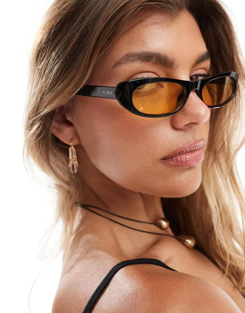 Shop Aire Avior slim oval sunglasses in black with amber  display picture 1