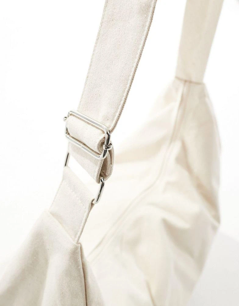 ASOS ASOS DESIGN oversized half moon sling cross body bag in ecru 3