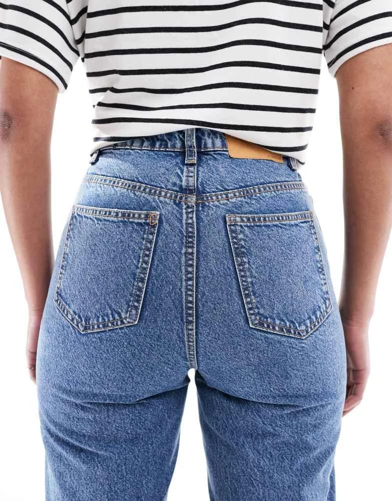 Shop ASOS DESIGN Tall high rise relaxed mom jeans in mid blue on