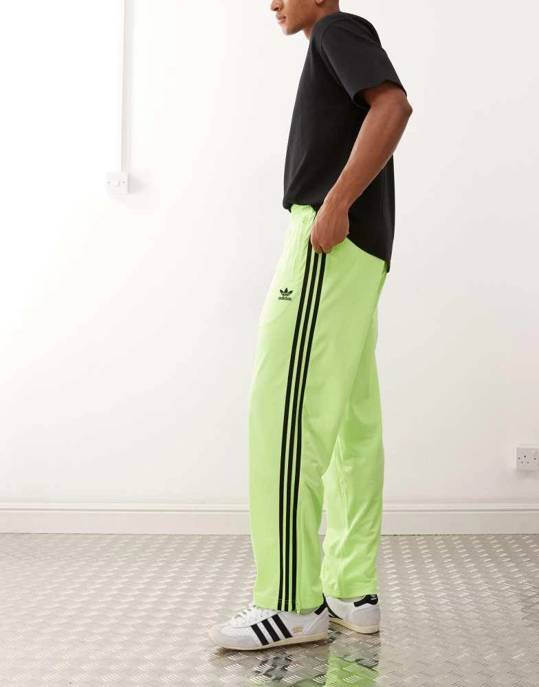 Adidas adidas Originals Firebird track pants in green and black 1