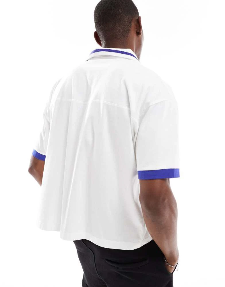 ASOS ASOS DESIGN boxy oversized polo with cut and sew and sports graphics in white 3